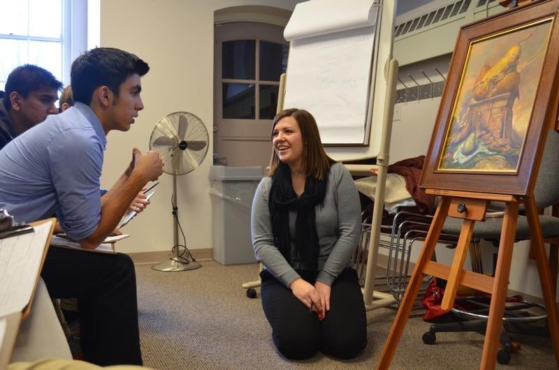 Students from Algonquin High School attend an exhibit of Samuel Bak paintings at the Facing History Brookline offices.