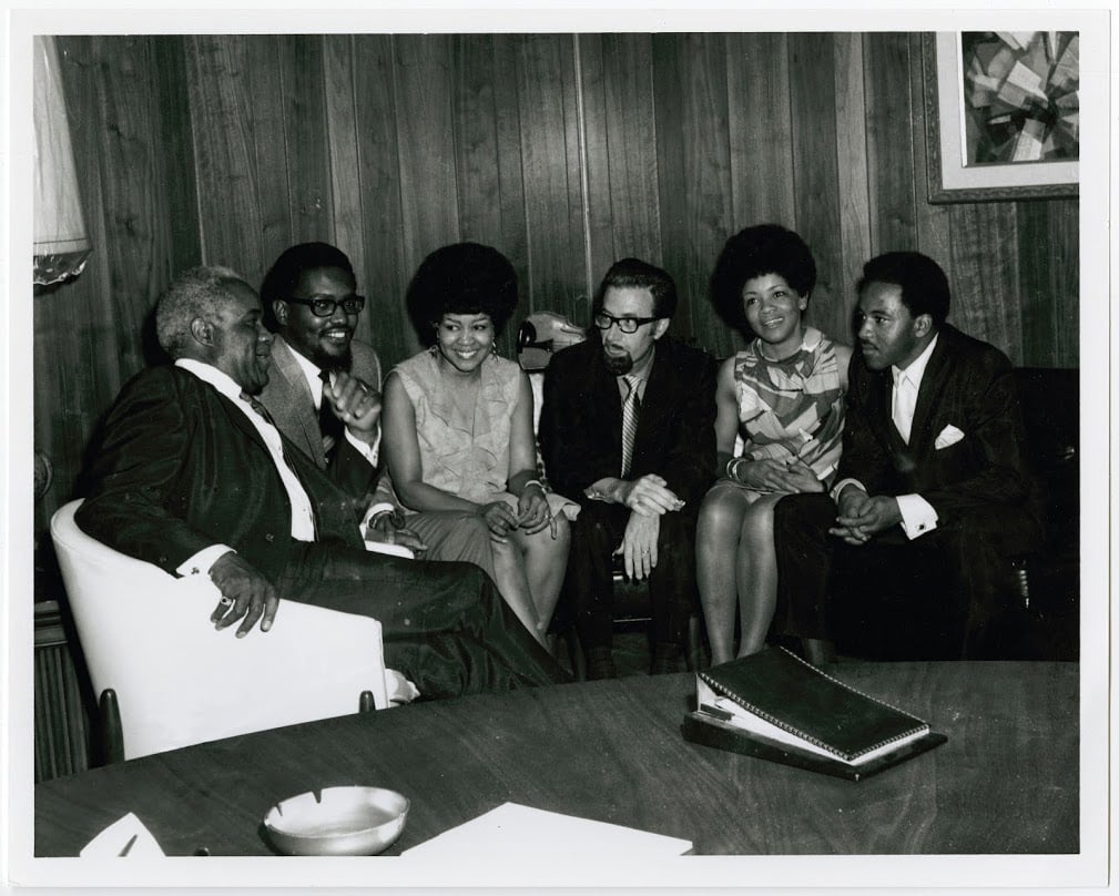 The Staple Singers sit with the owners of Stax Records, Al Bell and Jim Stewart, in Memphis, TN. Photo courtesy of Stax Museum of American Soul Music.