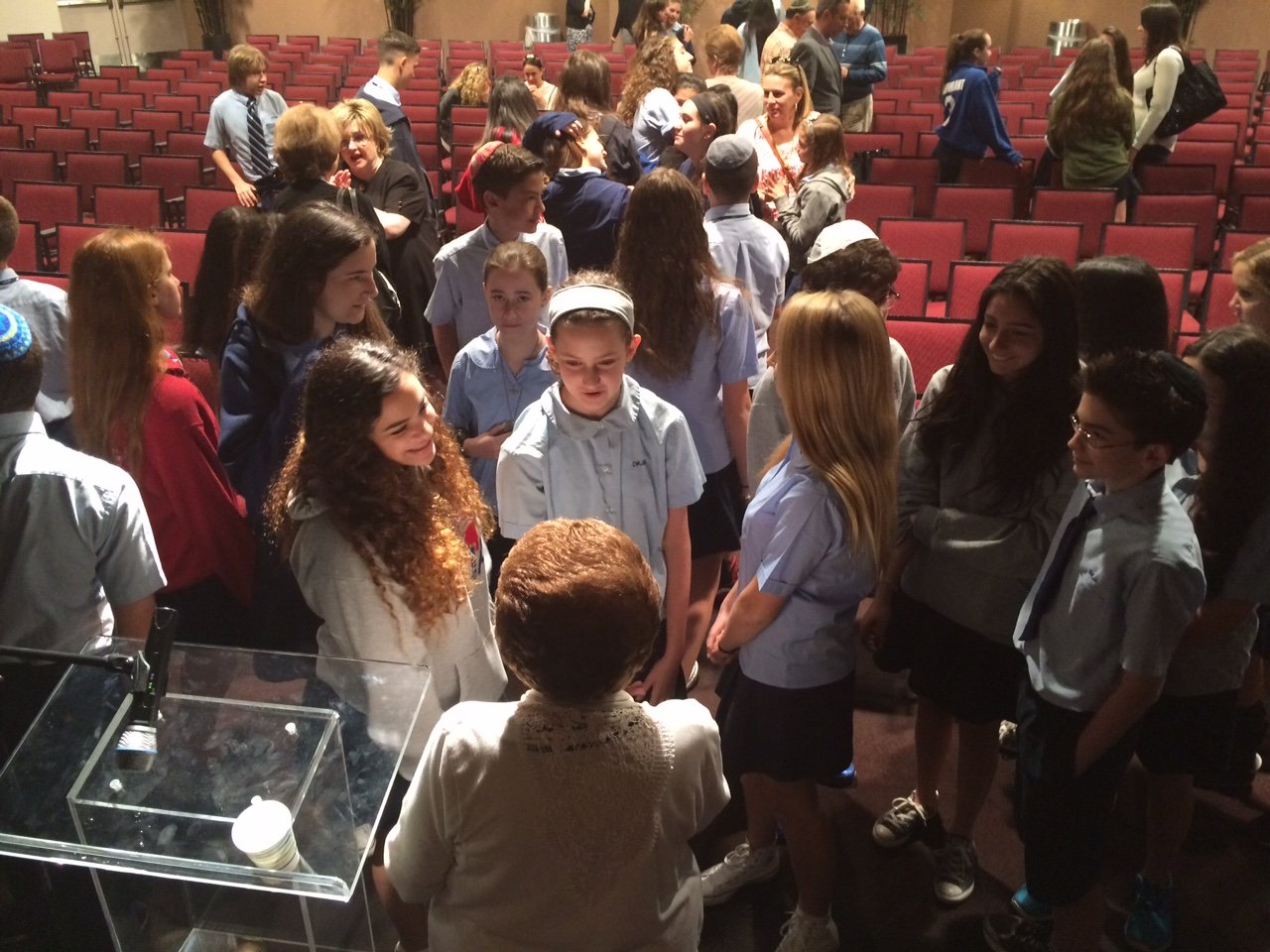 Yaffa Englander and her classmates speak with Holocaust survivor Rena Finder