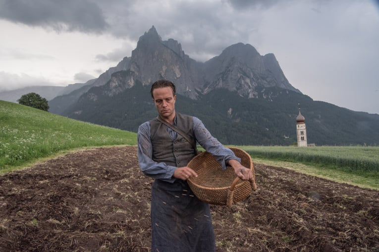 Farmer Franz Jägerstätter planting seeds in St. Radegund, Austria (portrayed by August Diehl in A HIDDEN LIFE). Image Credit: Photo by Reiner Bajo. © 2019 Twentieth Century Fox Film Corporation All Rights Reserved