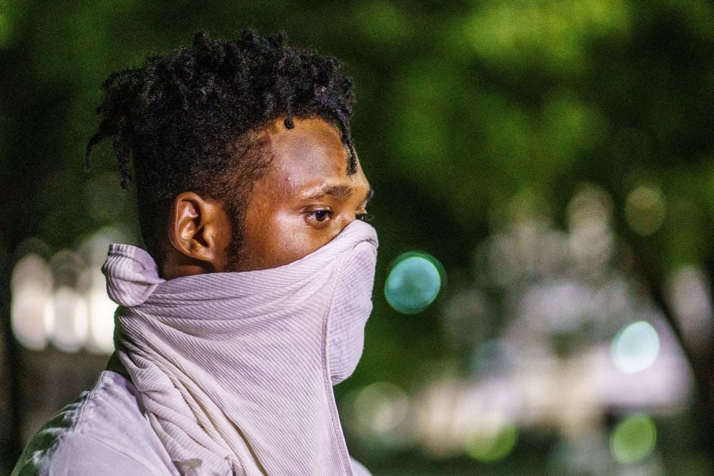 A protester uses his shirt as a mask during a demonstration against the shooting of Jacob Blake in Kenosha, Wisconsin on August 26, 2020