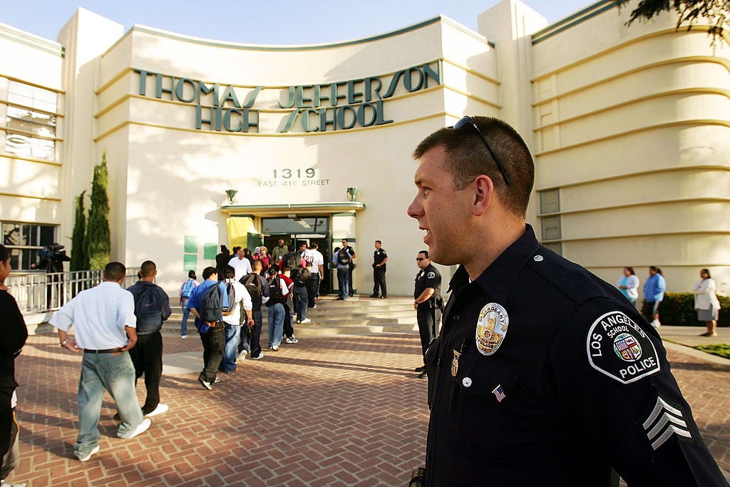 Police officer standing outside of a school