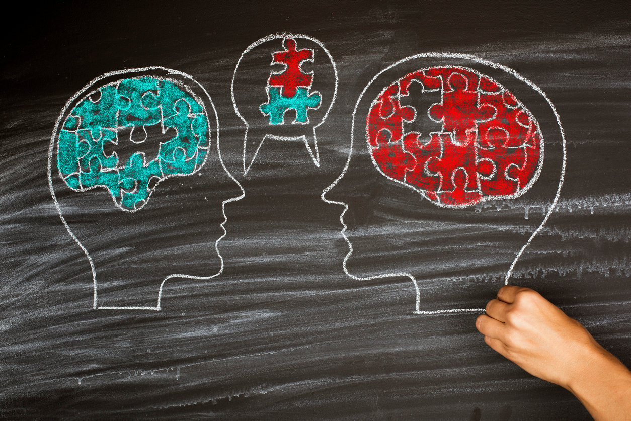 Heads talking on a blackboard